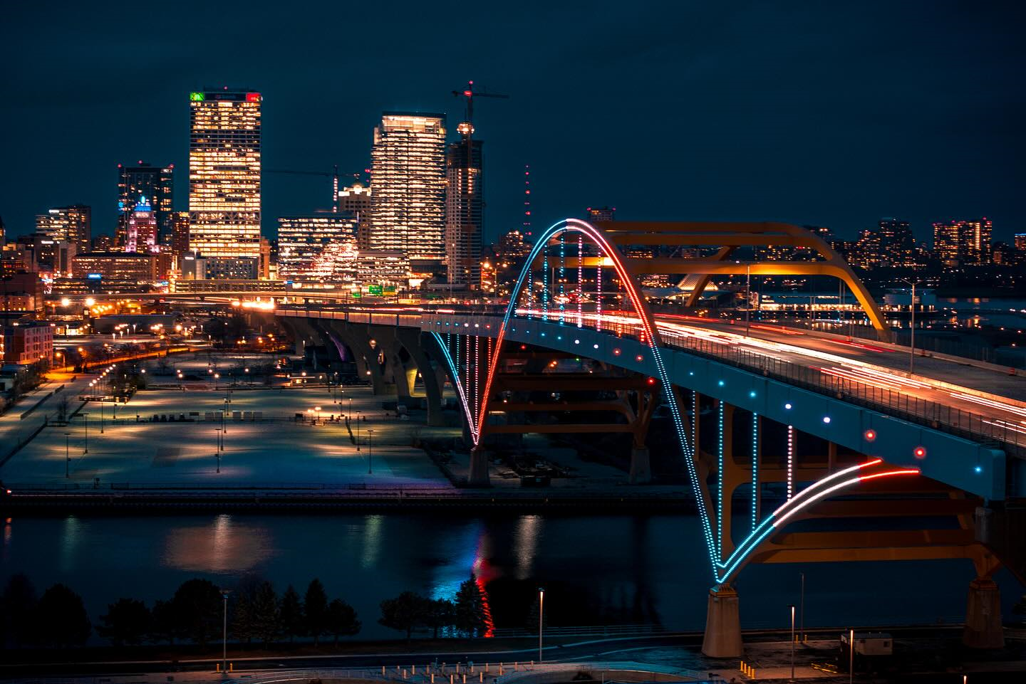 The Daniel W. Hoan Bridge and Milwaukee skyline lit up at dusk